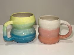 Ombre bubble mugs; $45 each Two colourful bubble mugs. On the left side, the mug has an ombre pattern from yellow on top through medium below at the bottom. On the right, a smaller mug features an ombre colour effect with white on top and peachy-pink on the bottom.